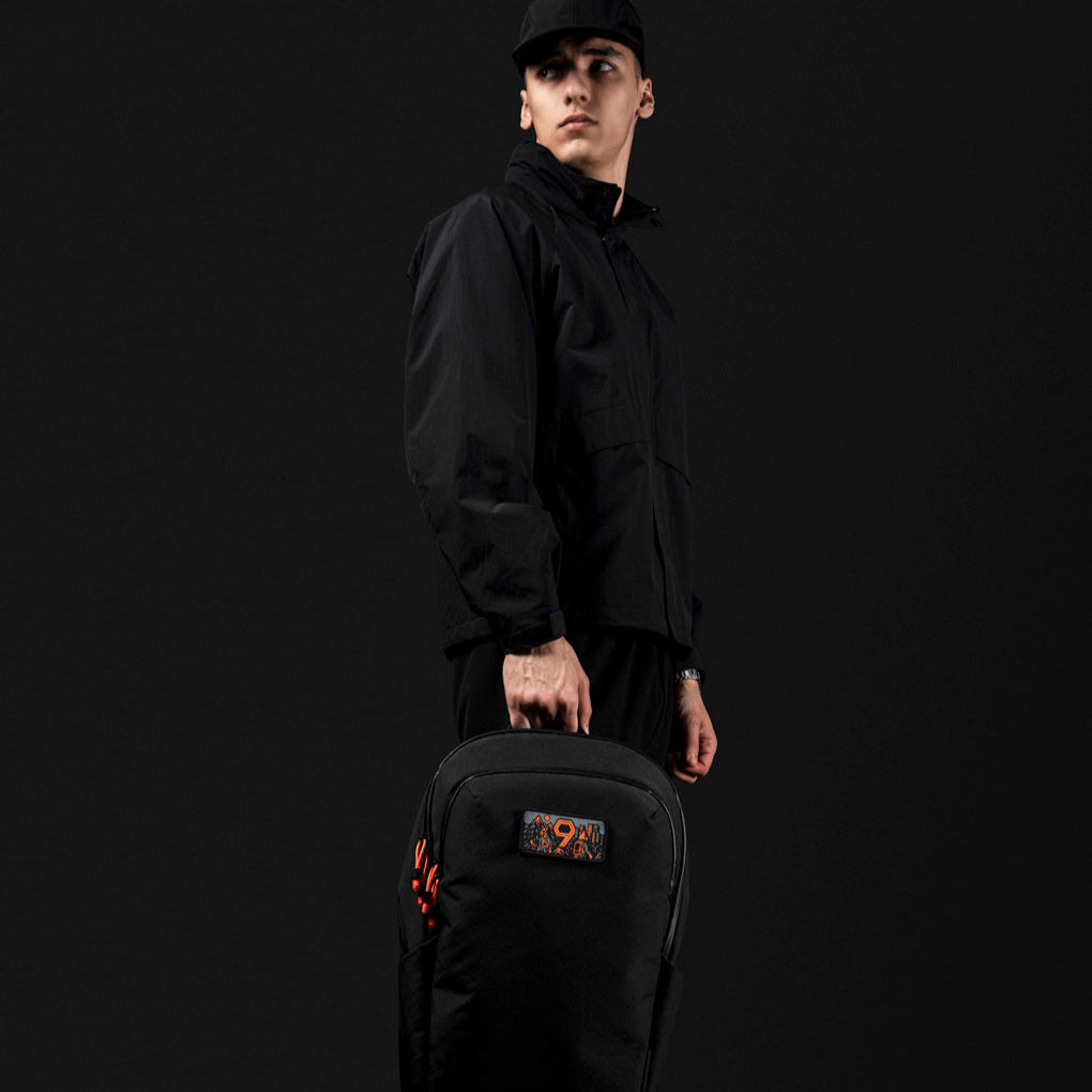 ALPAKA Bravo Backpack 正面展示：展示背包外觀及橙色拉鍊細節。